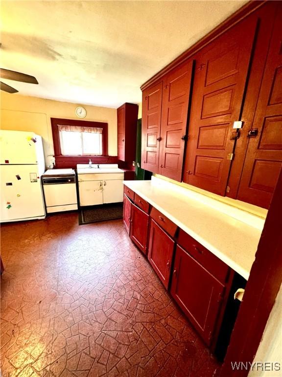 6723 Akron Rd, Lockport Town, NY 14094 - kitchen with freestanding refrigerator, dishwashing machine, ceiling fan, light countertops, and a sink