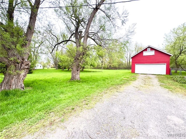 6723 Akron Rd, Lockport Town, NY 14094 - view of green lawn with an outdoor structure, driveway, and a garage