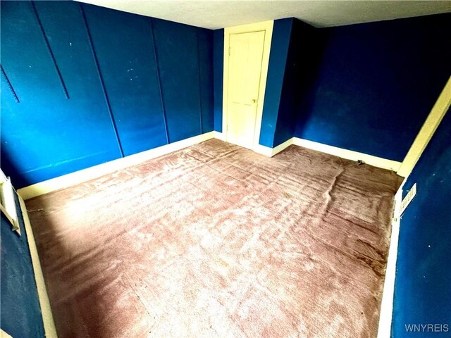 6723 Akron Rd, Lockport Town, NY 14094 - unfurnished bedroom with baseboards, carpet flooring, and a closet