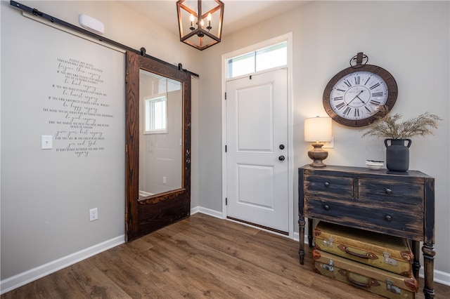 8 Colten Ct, Penfield, NY 14580 - entrance foyer featuring dark wood finished floors, baseboards, a barn door, and a chandelier