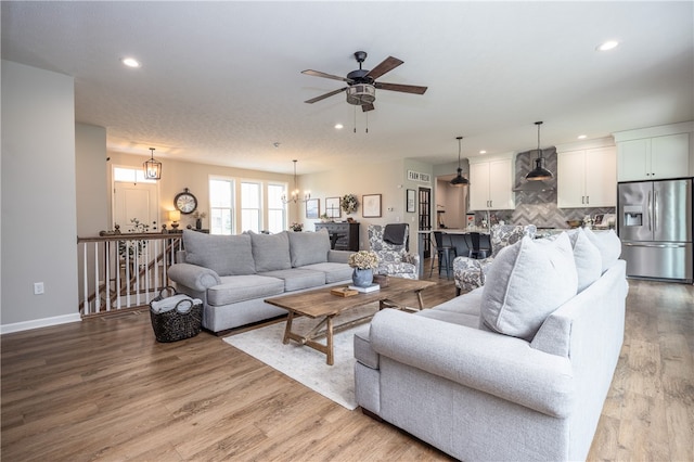 8 Colten Ct, Penfield, NY 14580 - living area with recessed lighting, ceiling fan, wood finished floors, baseboards, and a chandelier