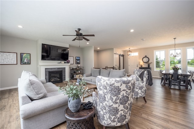 8 Colten Ct, Penfield, NY 14580 - living area with wood finished floors, baseboards, a glass covered fireplace, recessed lighting, and a ceiling fan