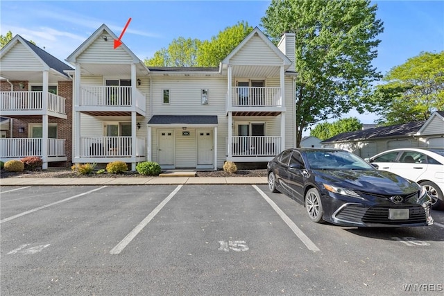 4613 Chestnut Ridge Rd Unit J, Amherst, NY 14228 - view of front facade with uncovered parking and a chimney