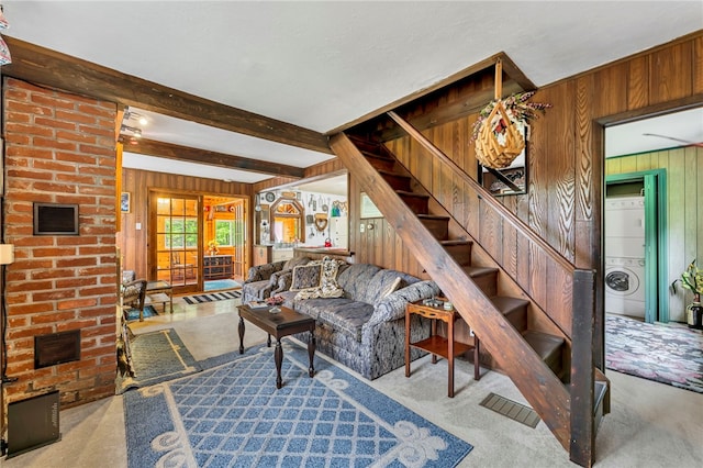 543 Middlefield Rd, Westford, NY 12155 - living area with stacked washer / drying machine, wood walls, carpet, stairway, and beam ceiling