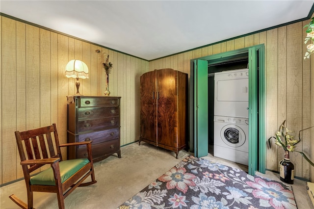 543 Middlefield Rd, Westford, NY 12155 - washroom featuring stacked washer and clothes dryer, carpet, wood walls, and ornamental molding