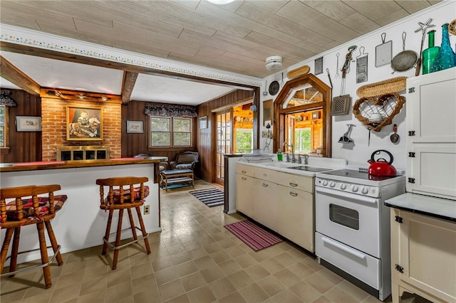 543 Middlefield Rd, Westford, NY 12155 - kitchen featuring white electric range oven, wood walls, open floor plan, a breakfast bar, and a wood ceiling with exposed beams