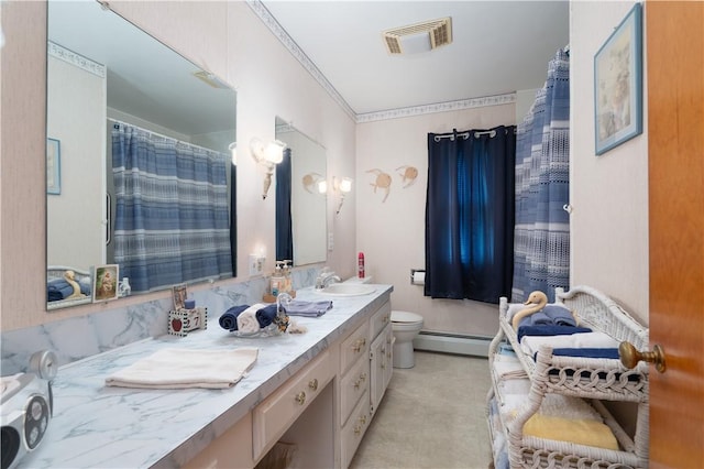 9 N Clinton St, North Dansville, NY 14437 - bathroom with a baseboard heating unit, double vanity, toilet, and curtained shower