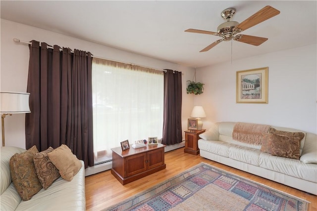 9 N Clinton St, North Dansville, NY 14437 - living room featuring a ceiling fan, light wood-type flooring, a baseboard radiator, and baseboard heating