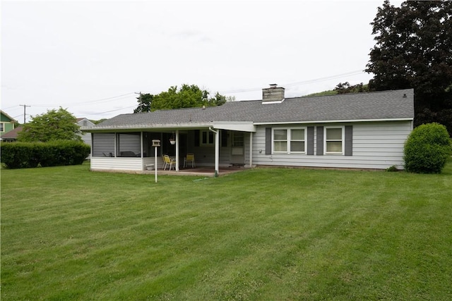 9 N Clinton St, North Dansville, NY 14437 - back of property featuring a lawn, a chimney, and a patio area