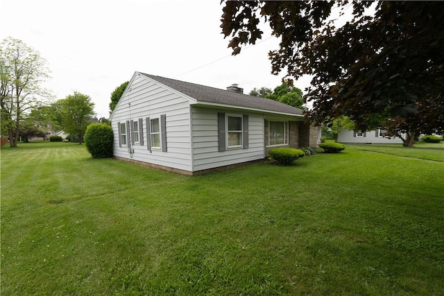 9 N Clinton St, North Dansville, NY 14437 - view of side of property with a chimney and a lawn