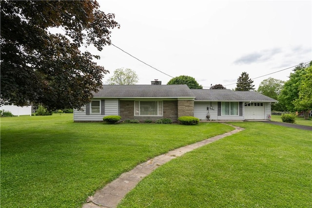 9 N Clinton St, North Dansville, NY 14437 - ranch-style house with driveway, a front lawn, a chimney, and stone siding