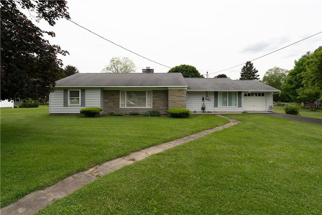 9 N Clinton St, North Dansville, NY 14437 - single story home featuring asphalt driveway, a front yard, a chimney, and stone siding