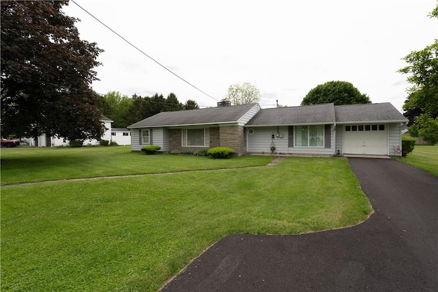 9 N Clinton St, North Dansville, NY 14437 - ranch-style home featuring an attached garage, driveway, and a front lawn
