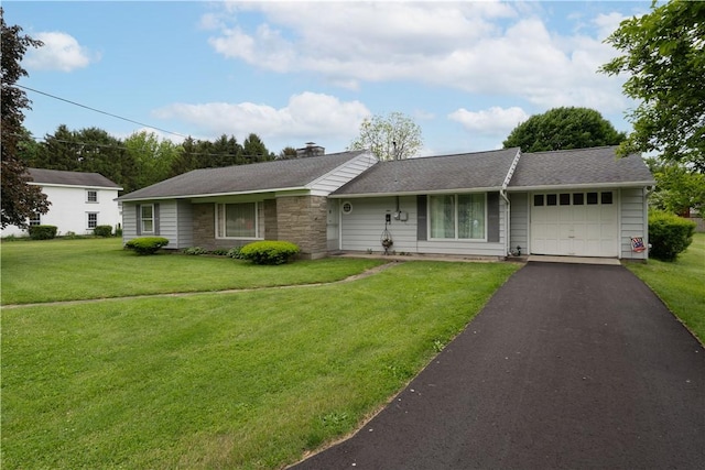 9 N Clinton St, North Dansville, NY 14437 - single story home featuring a garage, asphalt driveway, a front yard, a chimney, and stone siding