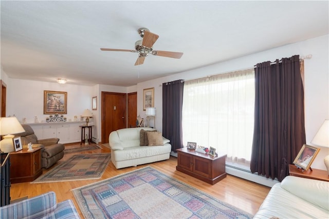9 N Clinton St, North Dansville, NY 14437 - living area featuring baseboard heating, healthy amount of natural light, a ceiling fan, and light wood-style floors