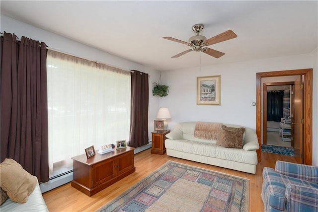 9 N Clinton St, North Dansville, NY 14437 - living room with a baseboard heating unit, a ceiling fan, and light wood-style flooring
