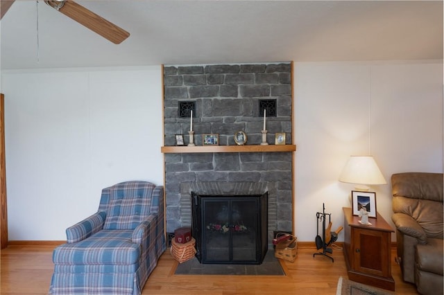 9 N Clinton St, North Dansville, NY 14437 - living area with wood finished floors, a fireplace, a ceiling fan, and baseboards