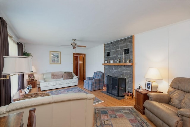 9 N Clinton St, North Dansville, NY 14437 - living area with wood finished floors, a stone fireplace, and ceiling fan