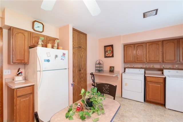 9 N Clinton St, North Dansville, NY 14437 - kitchen featuring washer / dryer, freestanding refrigerator, brown cabinets, and light countertops