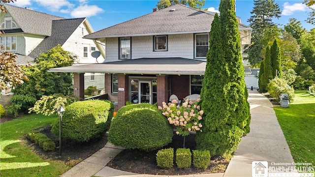 526 Central Ave, Dunkirk-City, NY 14048 - traditional style home with a front yard, brick siding, and covered porch
