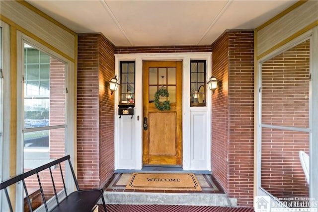 526 Central Ave, Dunkirk-City, NY 14048 - doorway to property featuring brick siding and a porch