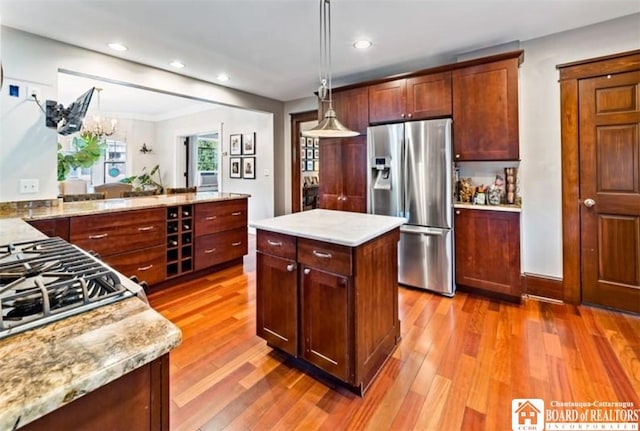 526 Central Ave, Dunkirk-City, NY 14048 - kitchen featuring stainless steel fridge, light wood-style flooring, recessed lighting, pendant lighting, and cooktop