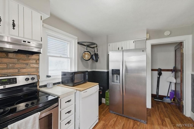 2902 Michigan Ave, Niagara Falls, NY 14305 - kitchen featuring appliances with stainless steel finishes, under cabinet range hood, light countertops, light wood-style floors, and white cabinetry