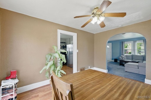 2902 Michigan Ave, Niagara Falls, NY 14305 - dining area featuring arched walkways, wood finished floors, baseboards, and ceiling fan