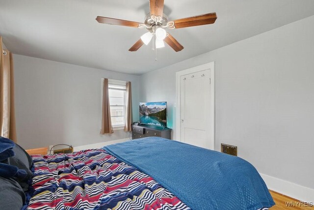 2902 Michigan Ave, Niagara Falls, NY 14305 - bedroom with baseboards, ceiling fan, and wood finished floors