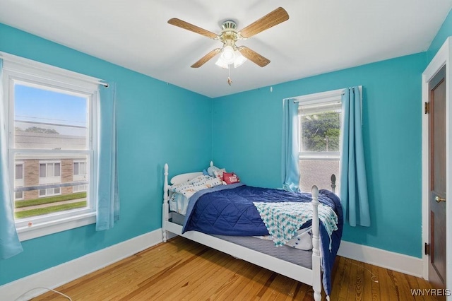 2902 Michigan Ave, Niagara Falls, NY 14305 - bedroom featuring baseboards, wood finished floors, and a ceiling fan