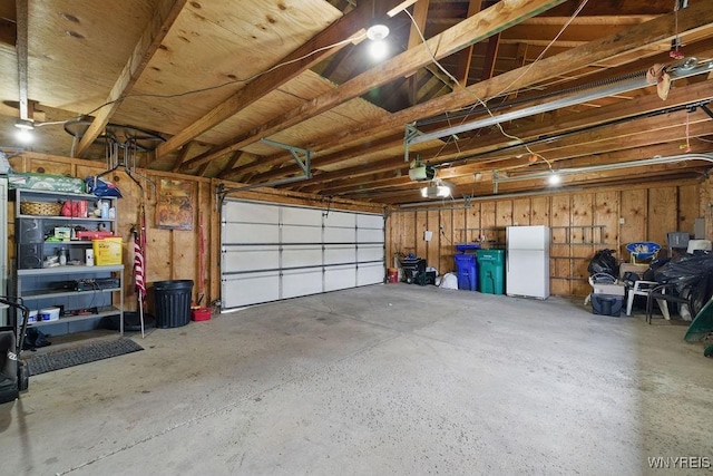 2902 Michigan Ave, Niagara Falls, NY 14305 - garage featuring freestanding refrigerator and a garage door opener