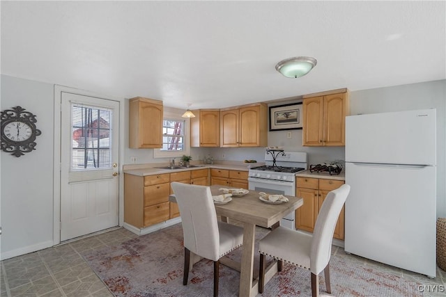 5435 Baldwin St, Cicero, NY 13029 - kitchen featuring white appliances, light countertops, light brown cabinets, a sink, and baseboards