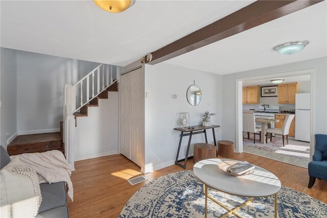 5435 Baldwin St, Cicero, NY 13029 - living area featuring stairway, light wood finished floors, and baseboards