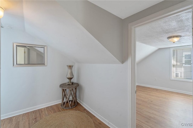 5435 Baldwin St, Cicero, NY 13029 - bonus room with vaulted ceiling, wood finished floors, and baseboards