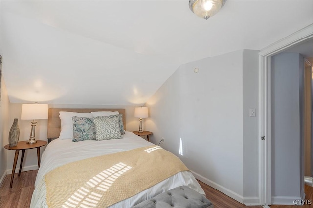 5435 Baldwin St, Cicero, NY 13029 - bedroom featuring wood finished floors, baseboards, and vaulted ceiling