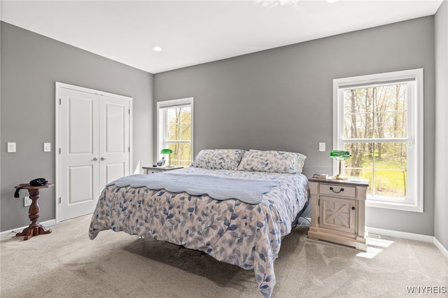 1167 Guinevere Dr, Greece, NY 14626 - bedroom with light colored carpet, baseboards, and a closet
