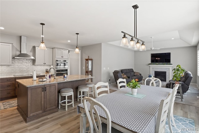 1167 Guinevere Dr, Greece, NY 14626 - dining room featuring recessed lighting, light wood-type flooring, and a fireplace
