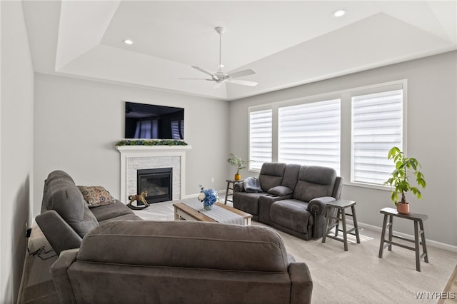 1167 Guinevere Dr, Greece, NY 14626 - living area with a tray ceiling, a ceiling fan, baseboards, light carpet, and plenty of natural light