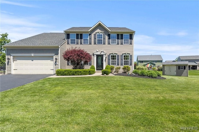 52 Apple Blossom Blvd, Lancaster, NY 14086 - colonial inspired home with asphalt driveway, an attached garage, and a front yard