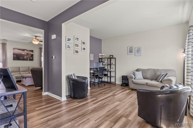 52 Apple Blossom Blvd, Lancaster, NY 14086 - living room featuring a desk, wood finished floors, ceiling fan, and baseboards