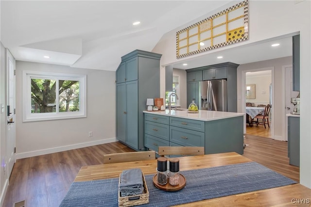 1607 Stolp Ave, Syracuse, NY 13207 - kitchen featuring stainless steel fridge, a sink, light countertops, vaulted ceiling, and baseboards