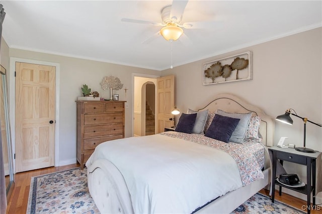 1607 Stolp Ave, Syracuse, NY 13207 - bedroom with light wood-type flooring, ornamental molding, arched walkways, ceiling fan, and baseboards