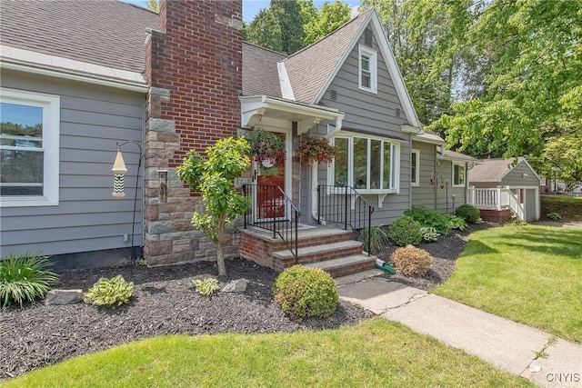 1607 Stolp Ave, Syracuse, NY 13207 - view of front of home featuring a front yard, a chimney, and a shingled roof