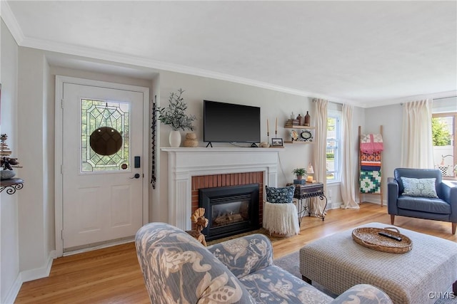 1607 Stolp Ave, Syracuse, NY 13207 - living area featuring light wood-style flooring, a brick fireplace, baseboards, and crown molding