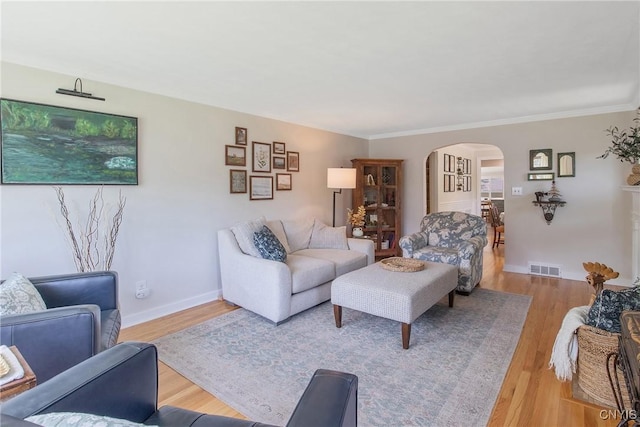 1607 Stolp Ave, Syracuse, NY 13207 - living area featuring arched walkways, wood finished floors, ornamental molding, and baseboards
