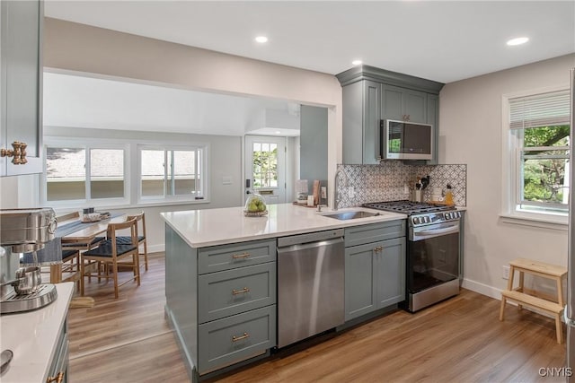 1607 Stolp Ave, Syracuse, NY 13207 - kitchen featuring appliances with stainless steel finishes, a sink, gray cabinets, light countertops, and recessed lighting