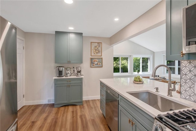 1607 Stolp Ave, Syracuse, NY 13207 - kitchen with appliances with stainless steel finishes, a sink, light countertops, light wood-style floors, and recessed lighting