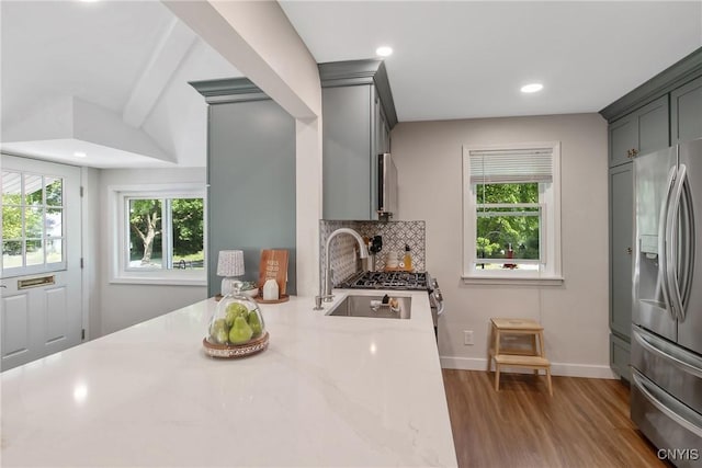 1607 Stolp Ave, Syracuse, NY 13207 - kitchen featuring stainless steel refrigerator with ice dispenser, wood finished floors, backsplash, baseboards, and recessed lighting