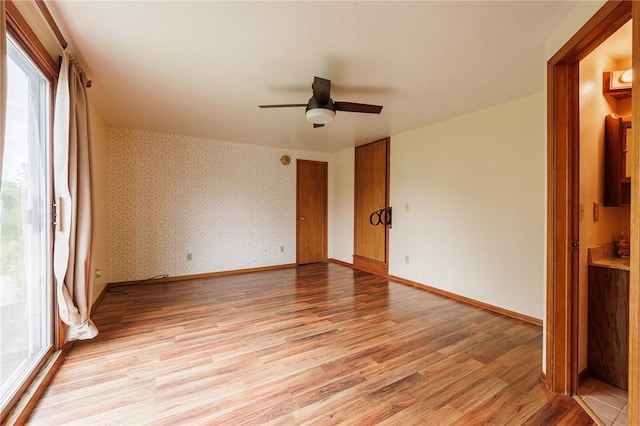 6695 Fisher Rd, Ontario, NY 14589 - unfurnished room featuring light wood-style flooring, ceiling fan, and baseboards