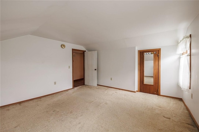 6695 Fisher Rd, Ontario, NY 14589 - empty room featuring lofted ceiling, light colored carpet, and baseboards